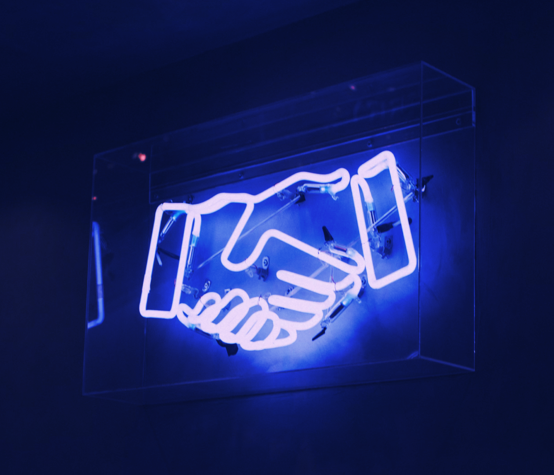 Illuminated blue handshake symbol for Cobo Ventures